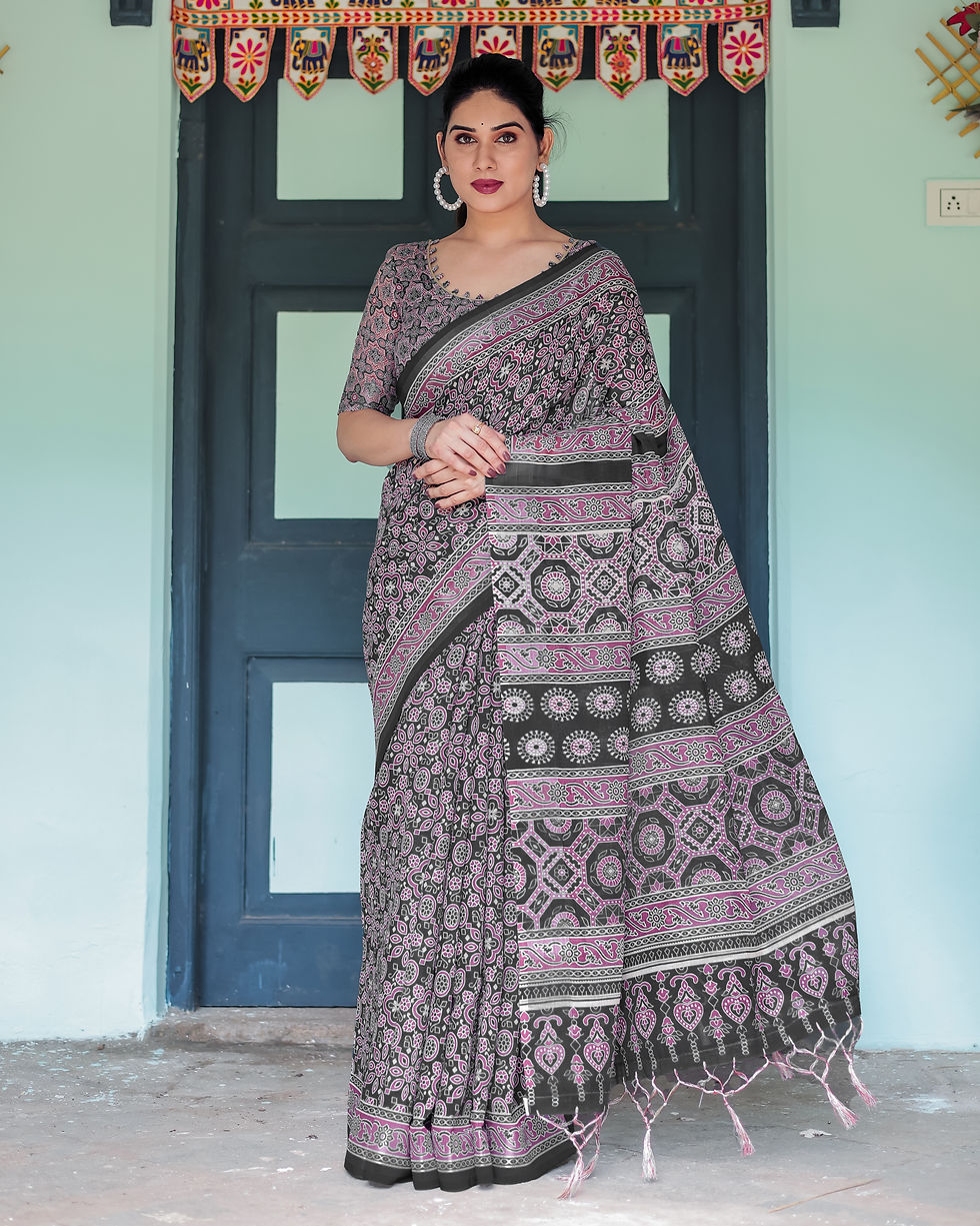 Full view of a woman in an elegant designer ethnic print saree with a contrast border for party wear.