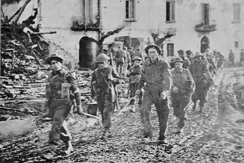 British troops pass through the ruined town of San Clement Italy, 1943