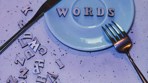 a blue plate with a word on it, with a knife and fork