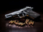 close-up-gun-surrounded-by-bullets.jpg