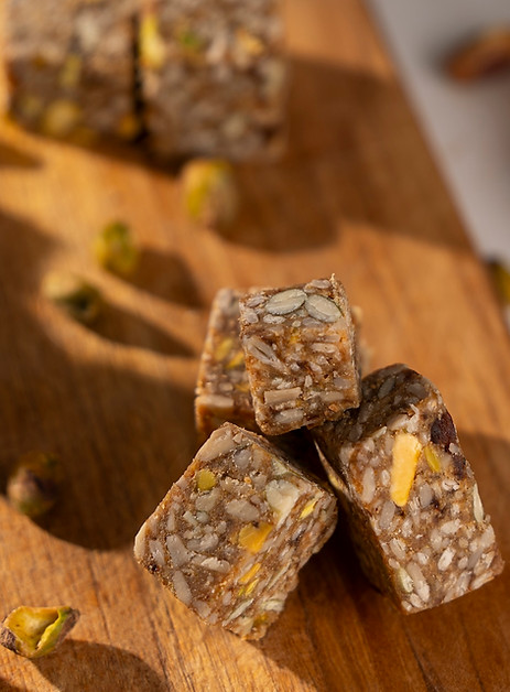 Delicious Organic Honey Pistachio Chunks of Energy with whole foods ingredients behind them.