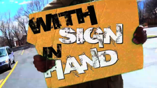 WITH SIGN IN HAND