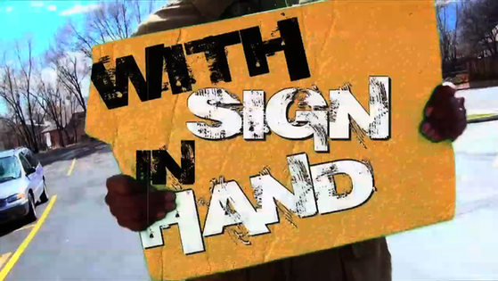 WITH SIGN IN HAND