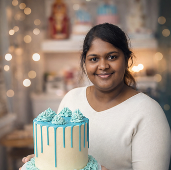 Student holding buttercream drip cake created during cake decorating class at Kimmi’s Cakes Swindon