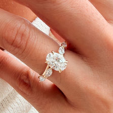 Detailed view of the Bryony oval lab-grown diamond engagement ring and graduated marquise diamond shoulders in yellow gold.