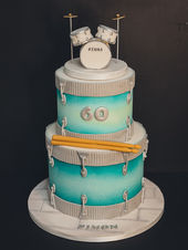 Bespoke drum kit themed 60th birthday cake with handcrafted fondant drumsticks, miniature drum set topper and personalised name plaque by Kimmi's Cakes Swindon.