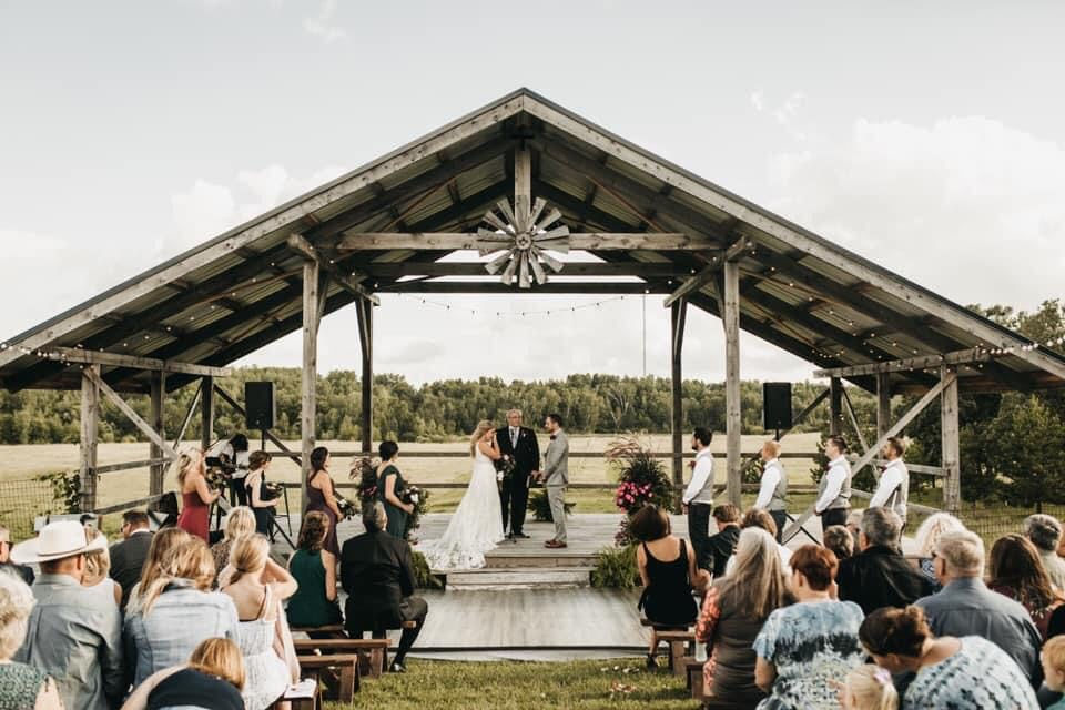 Bride and groom outdoor ceremony at FireFly Event Barn near Park Rapids MN