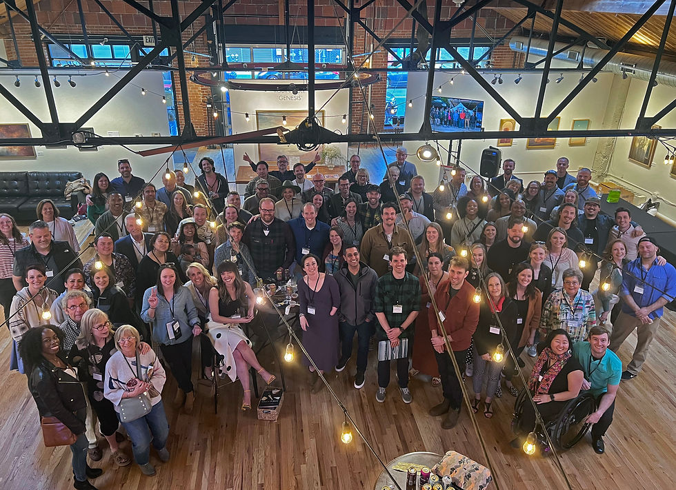 A group of 100 kind humans smiling at the camera