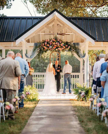 bride and groom getting married at waterfront garden wedding ceremony venue in north texas