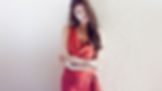 photo of a pretty girl in a red dress on a rough background