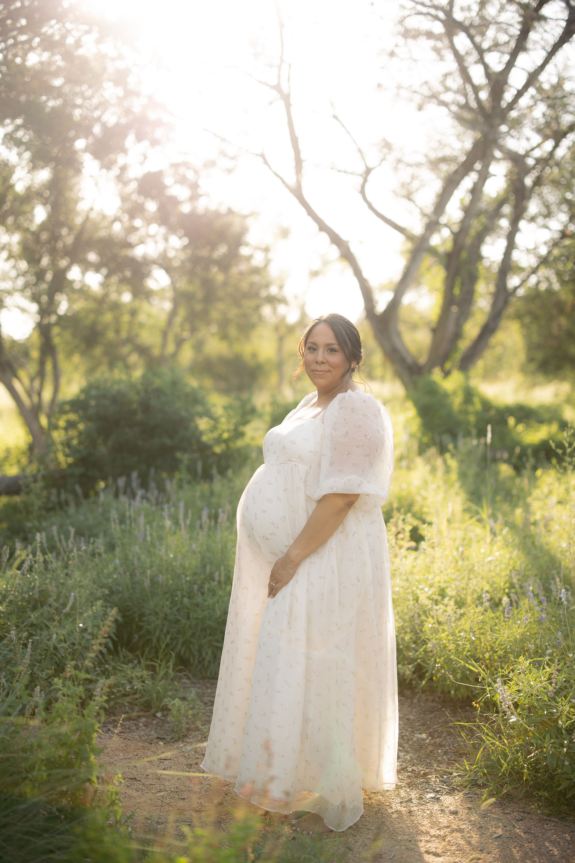 Natural maternity portrait of a smiling expecting mother in San Antonio, Texas.