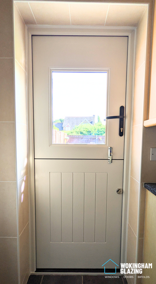 Rockdoor stable composite door in Chartwell green, side view, installed in Hook