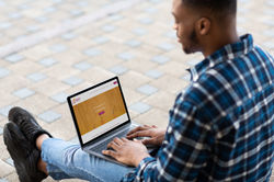 guy-using-laptop-sitting-on-the-border-m