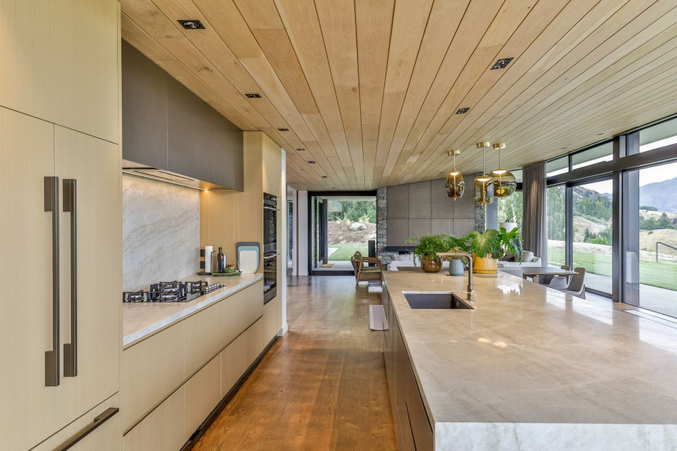 Raw Smoky Bronze overhead cupboard doors and panels above the fireplace.