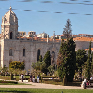 Jerónimos Monastery in Belém, Lisbon, surrounded by gardens and sunshine, featured in Hidden Gems of Portugal.