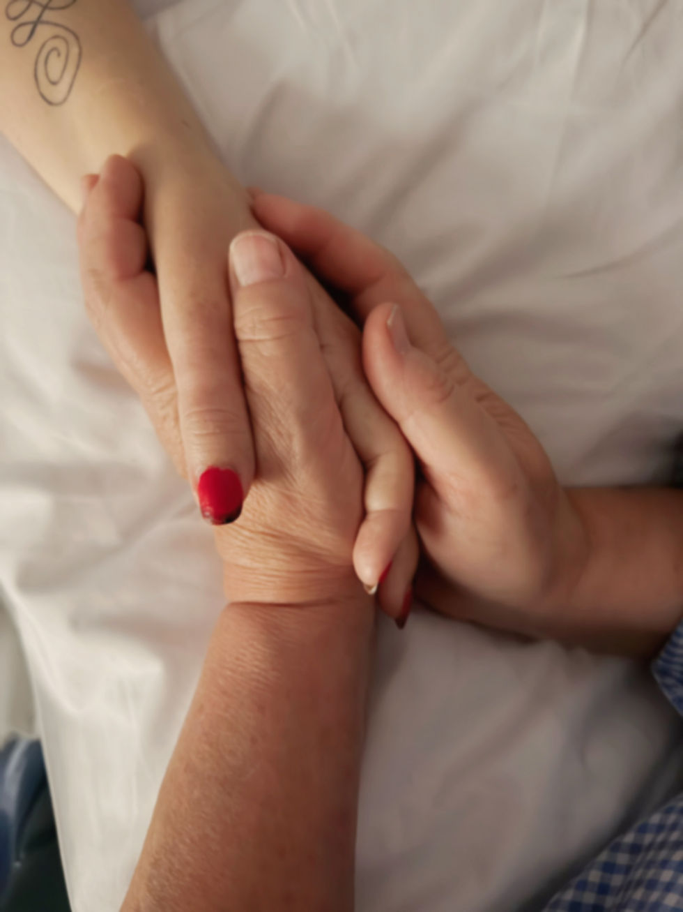 Close-up of  Louise and Bec's hands holding gently, symbolising grief, love and family connection in Louise’s Keeping Bec Close remembrance blog.