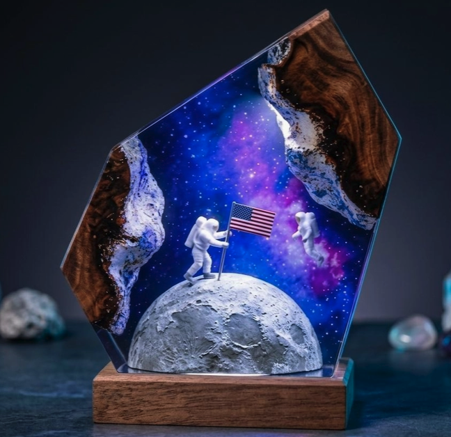 Astronauts on the moon with a glowing galaxy and wood surround