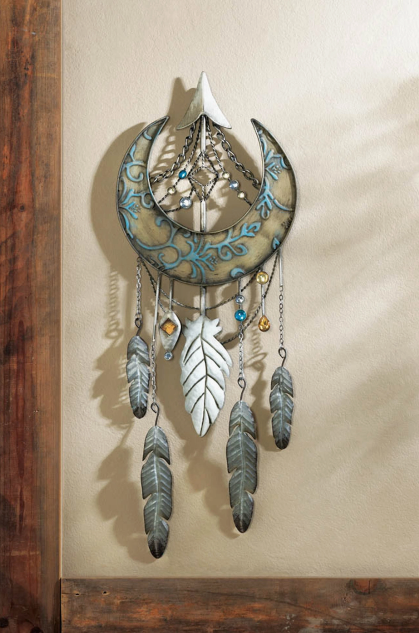 Metal Crescent moon dreamcatcher with feathers below shown on wall