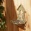 Thumbnail: Cast iron bird feeder on fence with design of two birds outside a bird house