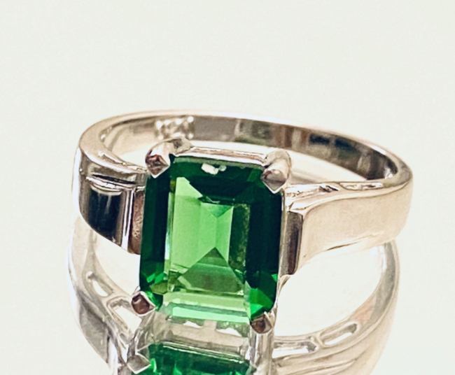 Square cut emerald green helenite stone on thicker silver ring band
