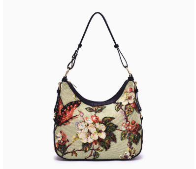 Floral and butterfly shoulder handbag with a black strap