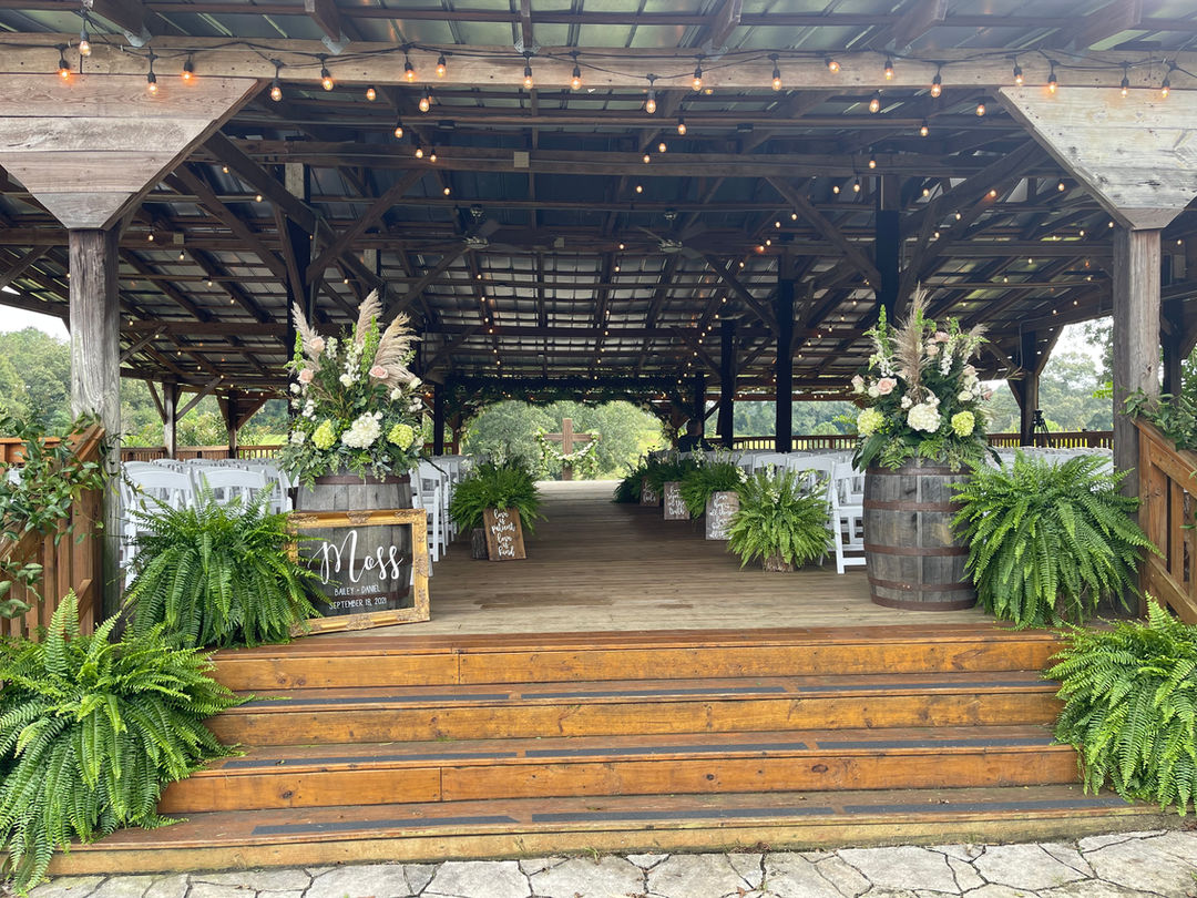 The Wedding Barn at L'Horne venue in middle Georgia featuring our pole barn ceremony site decorated with ferns