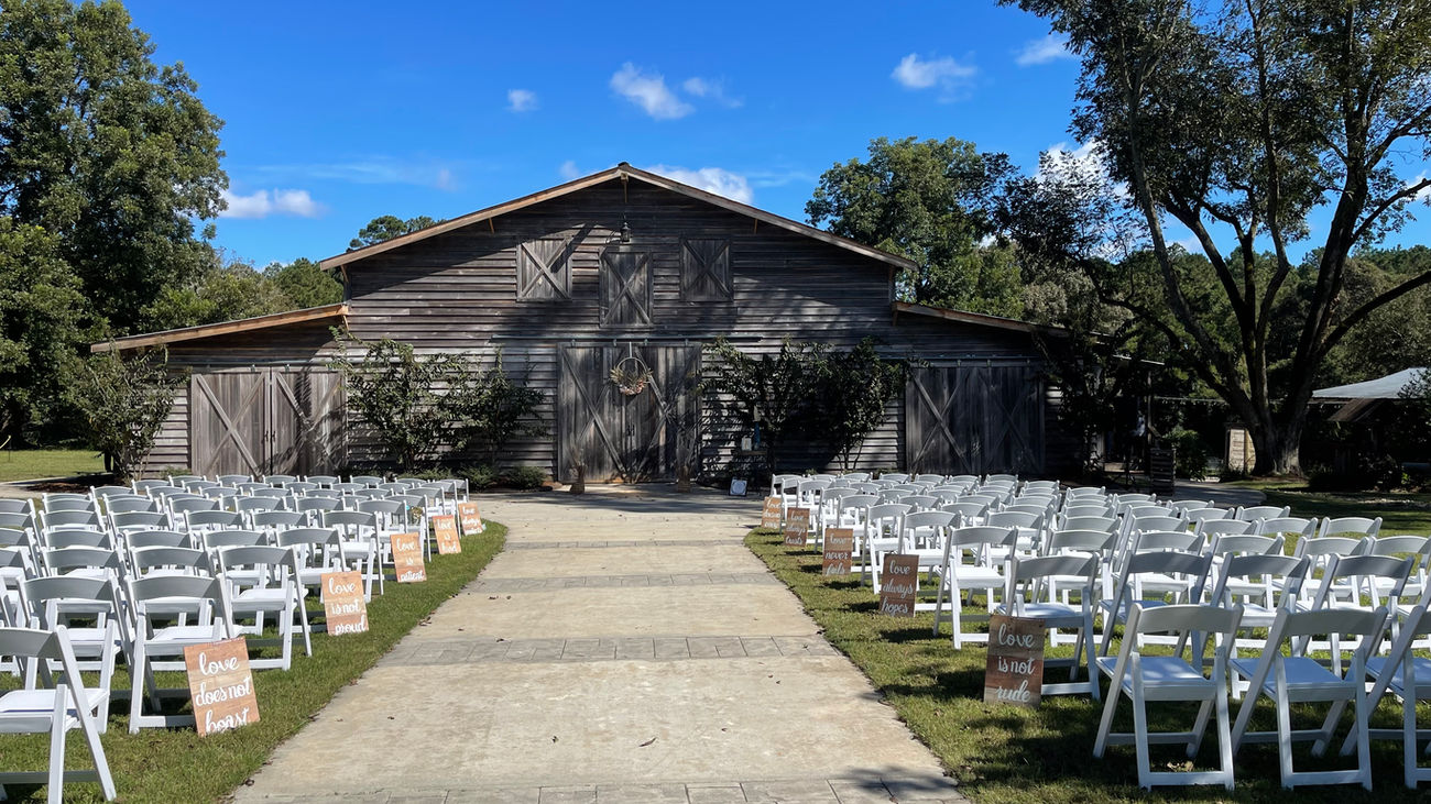 The Wedding Barn at L'Horne venue in middle Georgia featuring our walkway ceremony site facing the grand barn