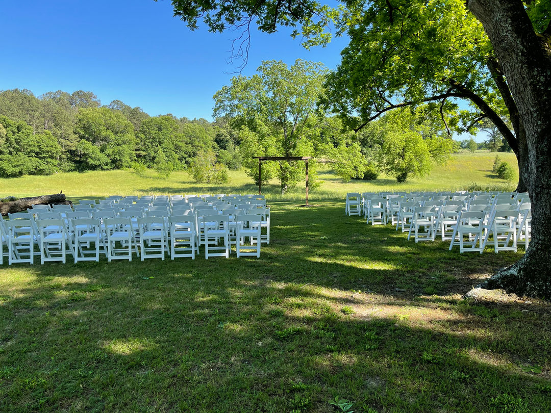 The Wedding Barn at L'Horne venue in middle Georgia featuring our double arch ceremony site facing the an old pecan tree 