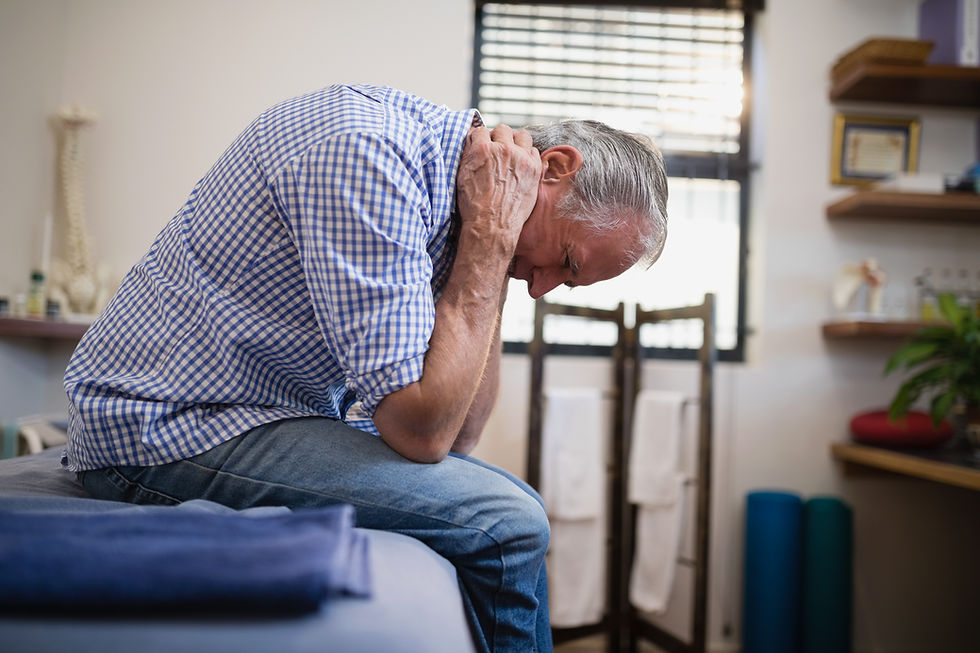 Elderly man clutching his neck because of chronic pain