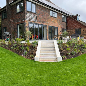 Contemporary family garden with wild, modern planting