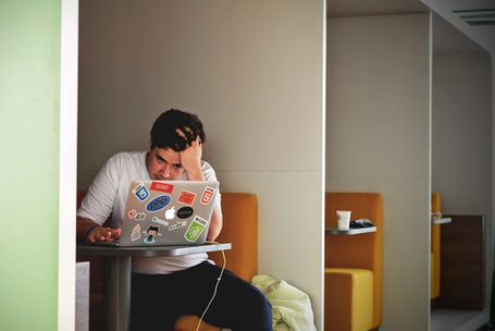 Young man working at the office, looking stressed