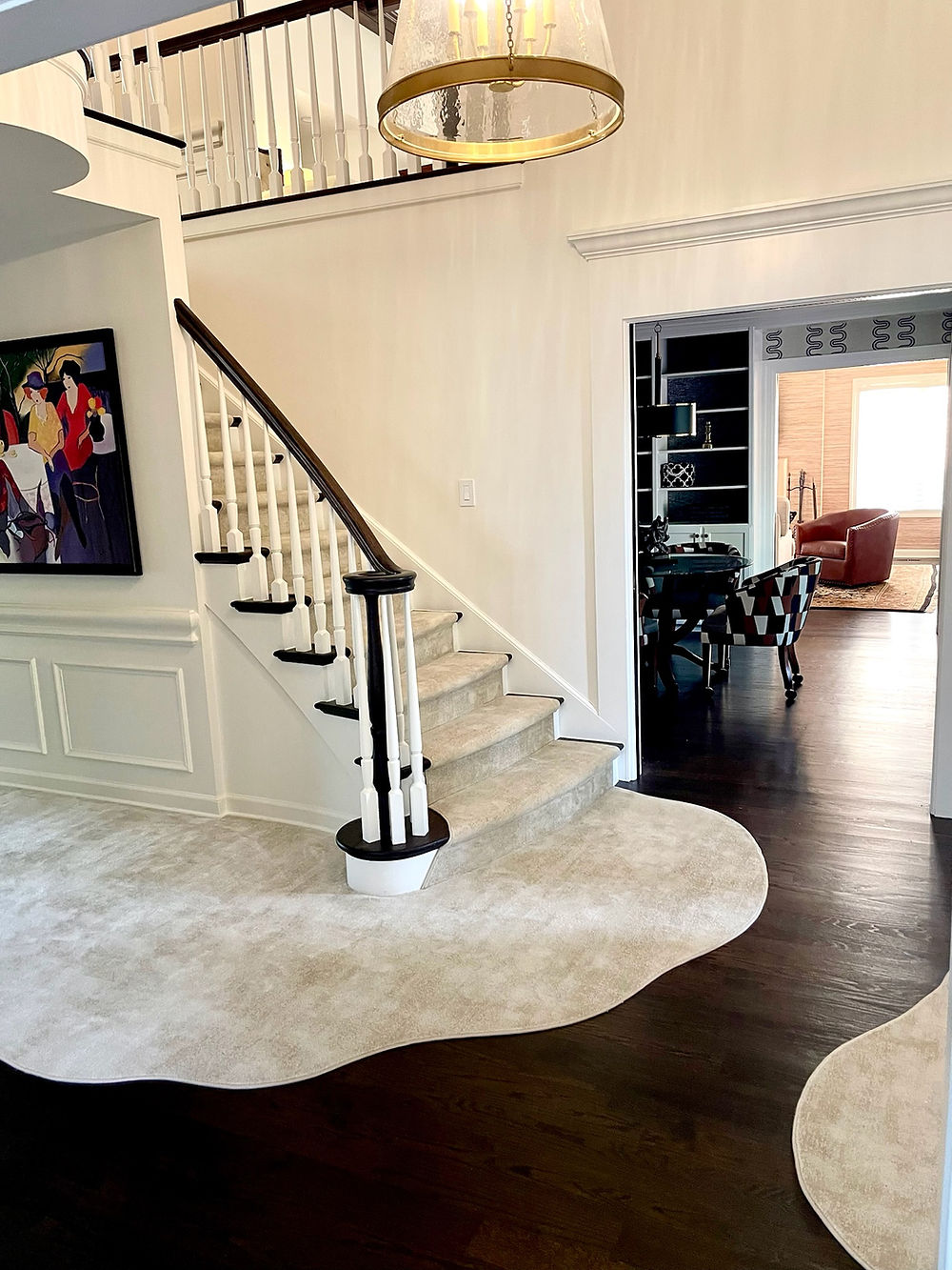 Elegant entryway with custom stair runner and floor rug.