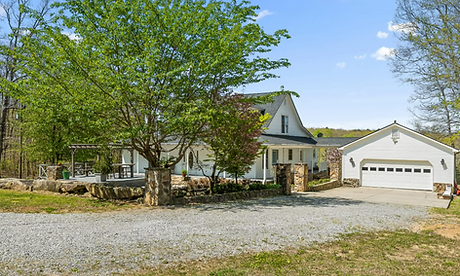 Custom white country home in Rising Fawn, Georgia with wraparound porch and stone accents