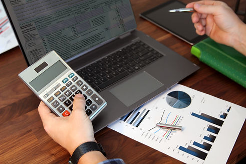 Businessman accountant is doing calculations. Tax return..jpg