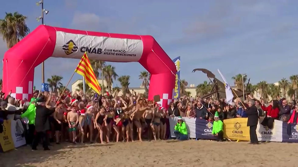 Hundreds take traditional New Year swim at Barcelona beach