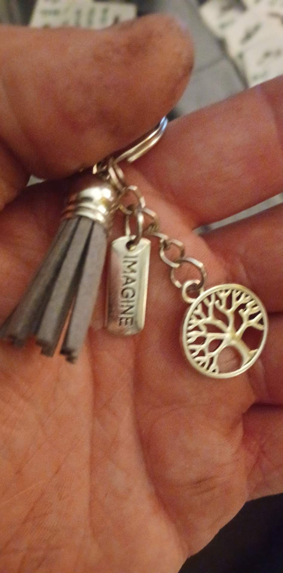 Thumbnail: Positive change zipper charms with tree of life charm attached 