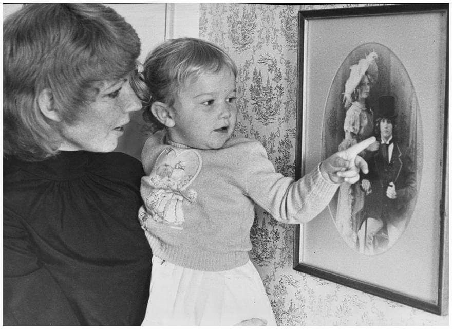 Andy's daughter Peta points to her father in a photograph