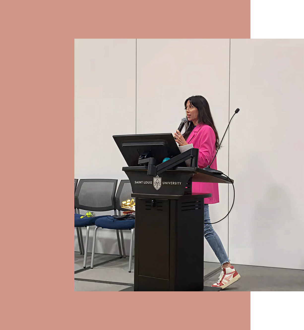 Kristel speaking at a podium (community workshop or presentation)