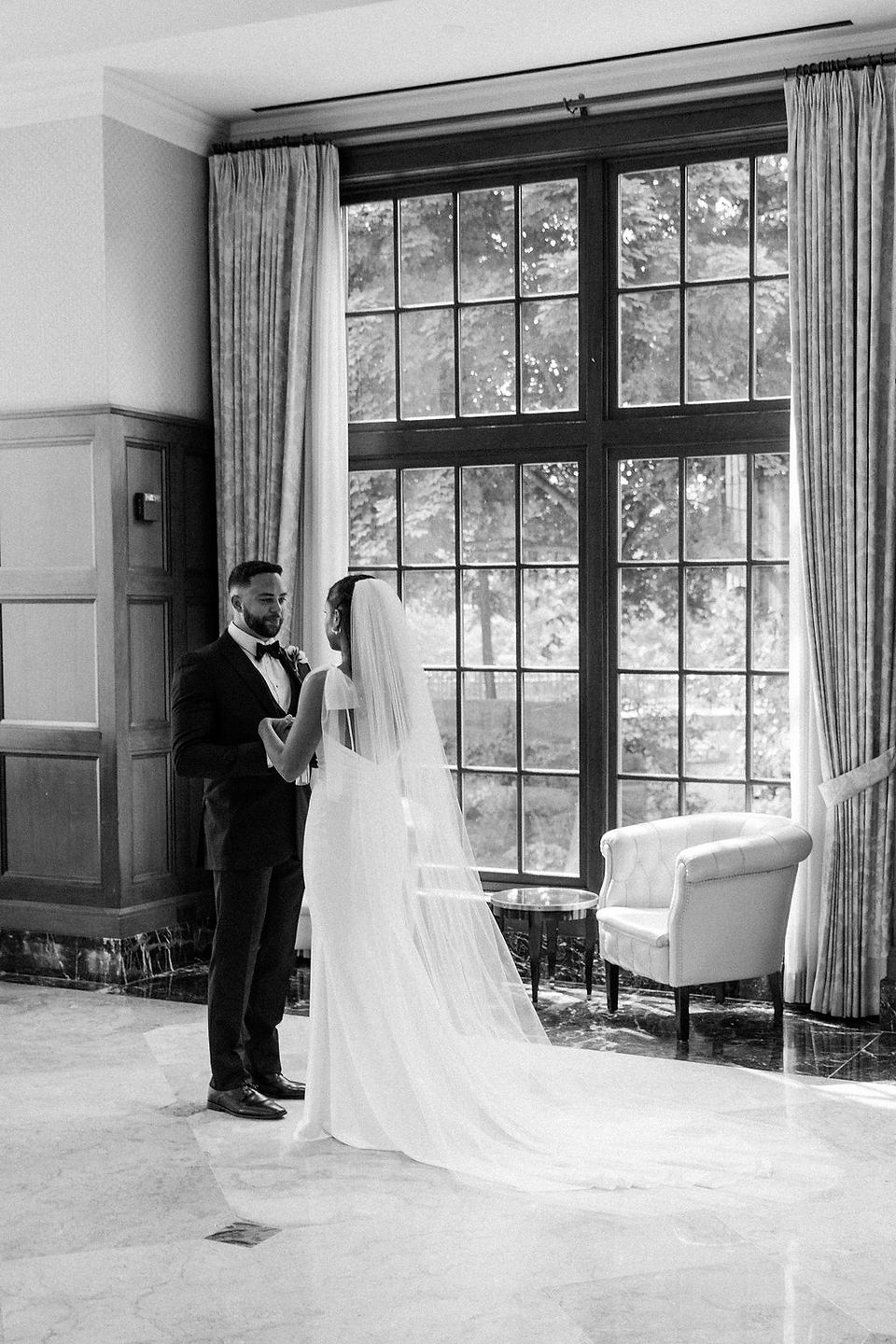 Black and white photo of the bride and groom after their first look at the Royal Park Hotel. 