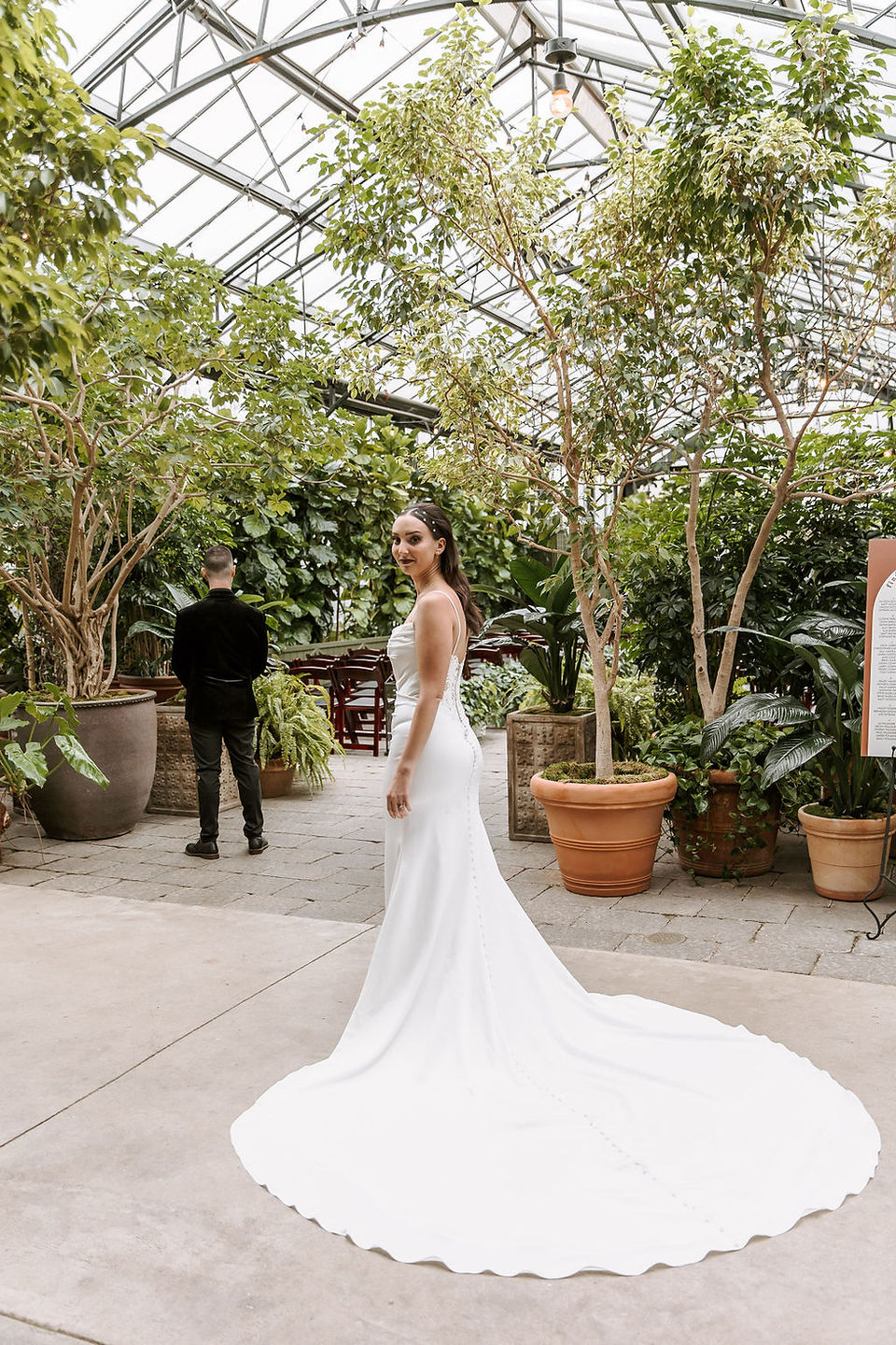 Bride and groom first look at the Planterra Conservatory surrounded by lush greenery.