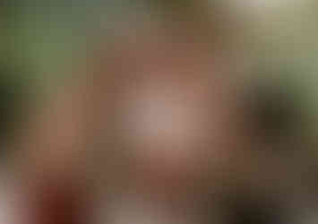 Bride with her bridesmaids holding vibrant bouquets.