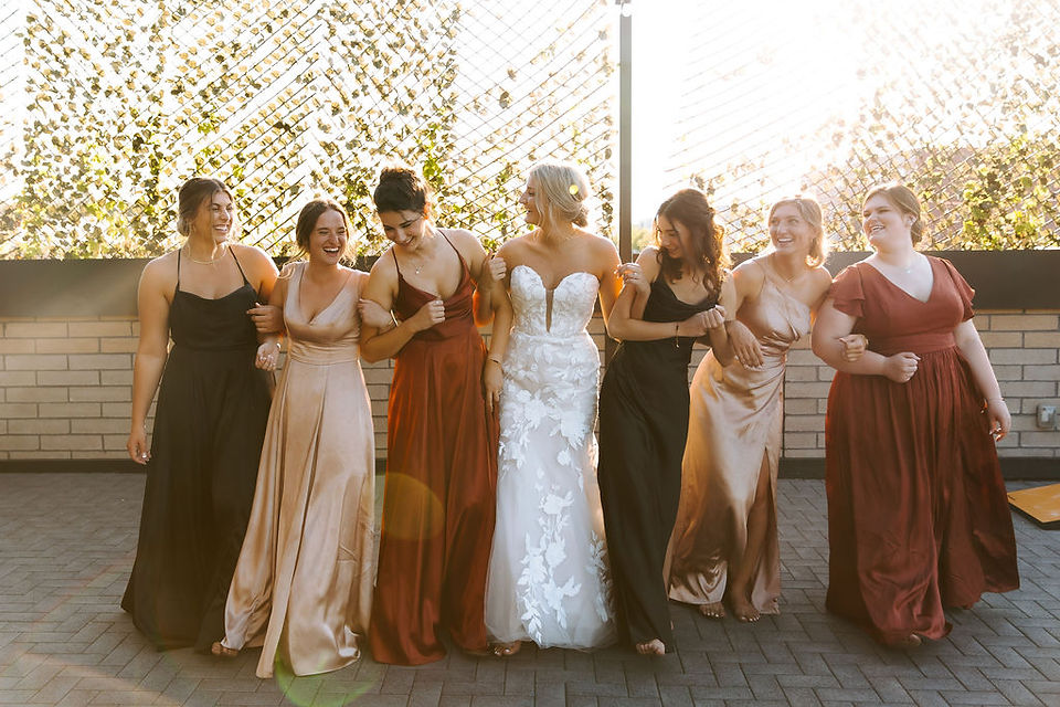 Bride and bridesmaid group photo at Port 393 in Holland, MI.