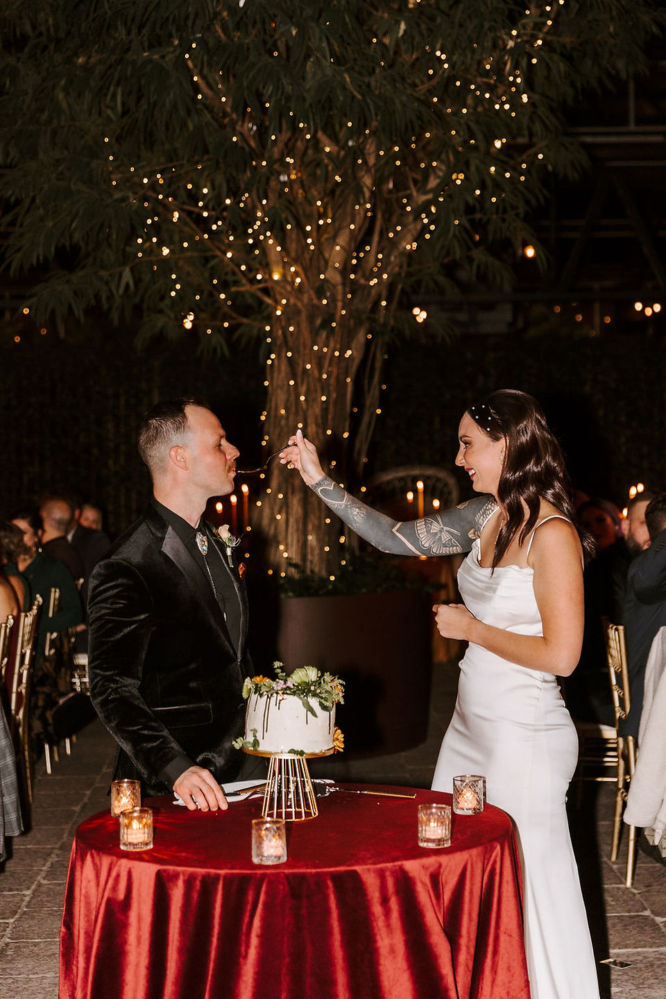 Bride feeding the groom a bite of wedding cake.