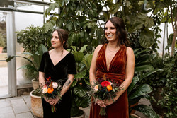Bridesmaids smiling as the bride walks down the aisle.