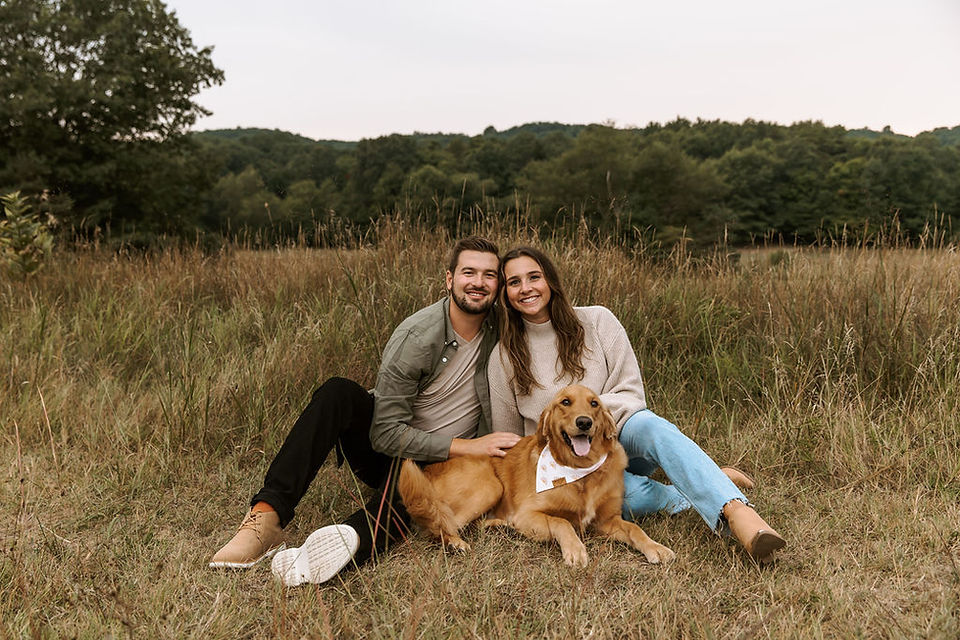Couple and golden retriever engagement photo.