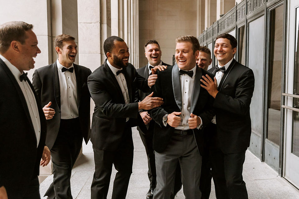 Groomsmen wedding day portrait outside The St. Andrew catholic church in Grand Rapids, Michigan.