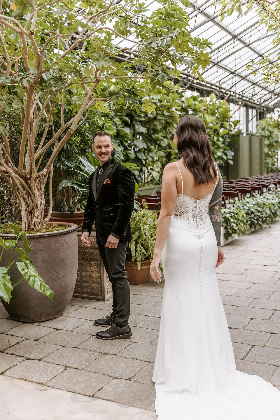 Groom's first look at the bride surrounded by lush greenery at the Planterra Conservatory.