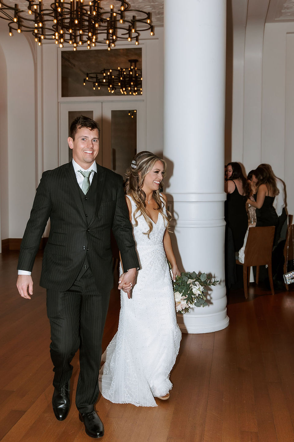 Bride and groom entering their wedding reception.