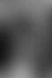 Black and white bridal portrait standing in front of a floral altar.