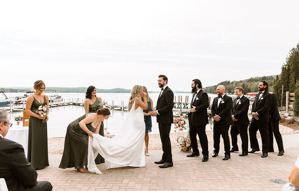 Bride and groom at the altar of their wedding ceremony with bridal party.